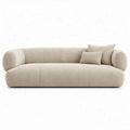 Crèmekleurige gebogen bouclé 3-zitsbank met 2 sierkussens, 225 x 95 x 72 cm